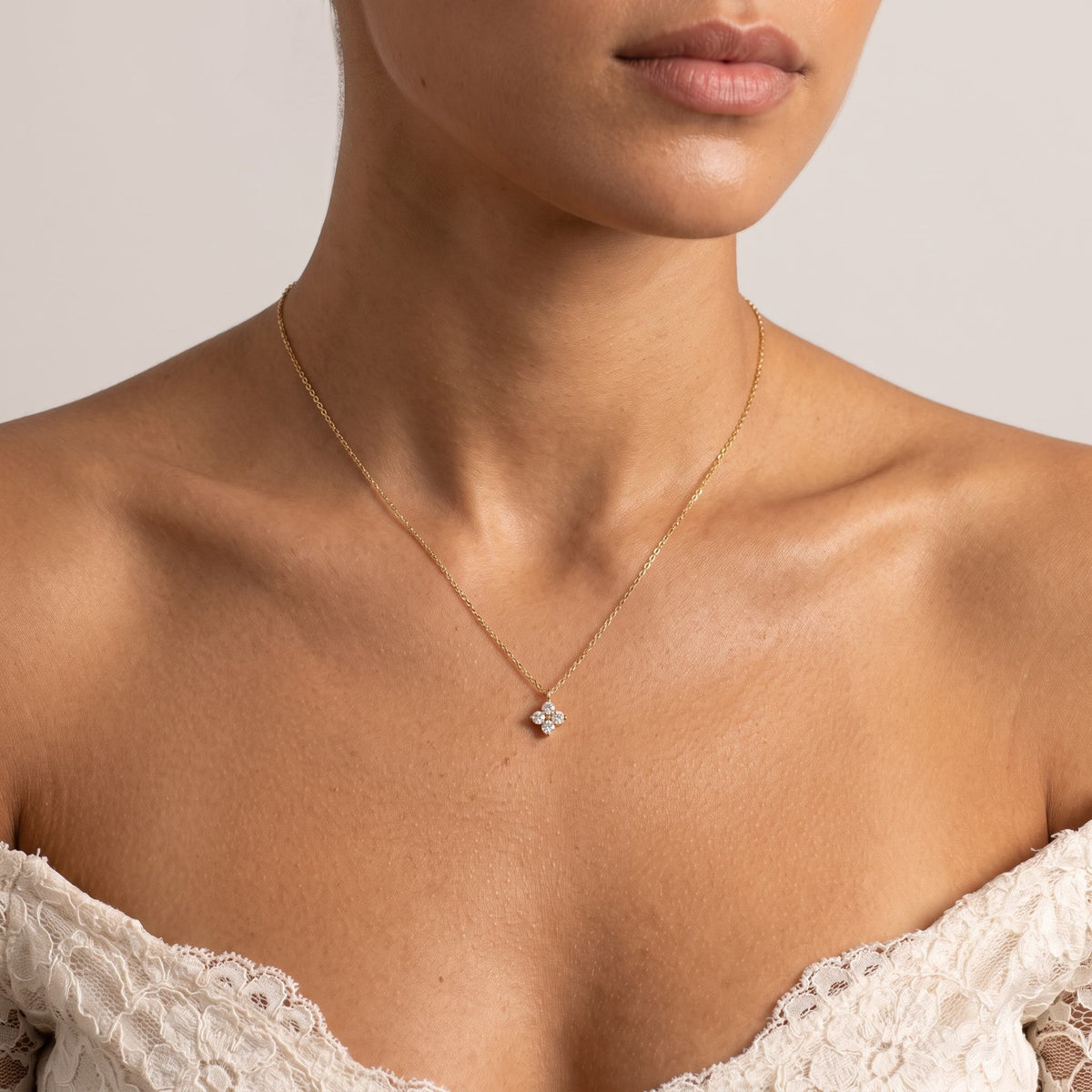 Wider view of a woman wearing the Four Petal Necklace