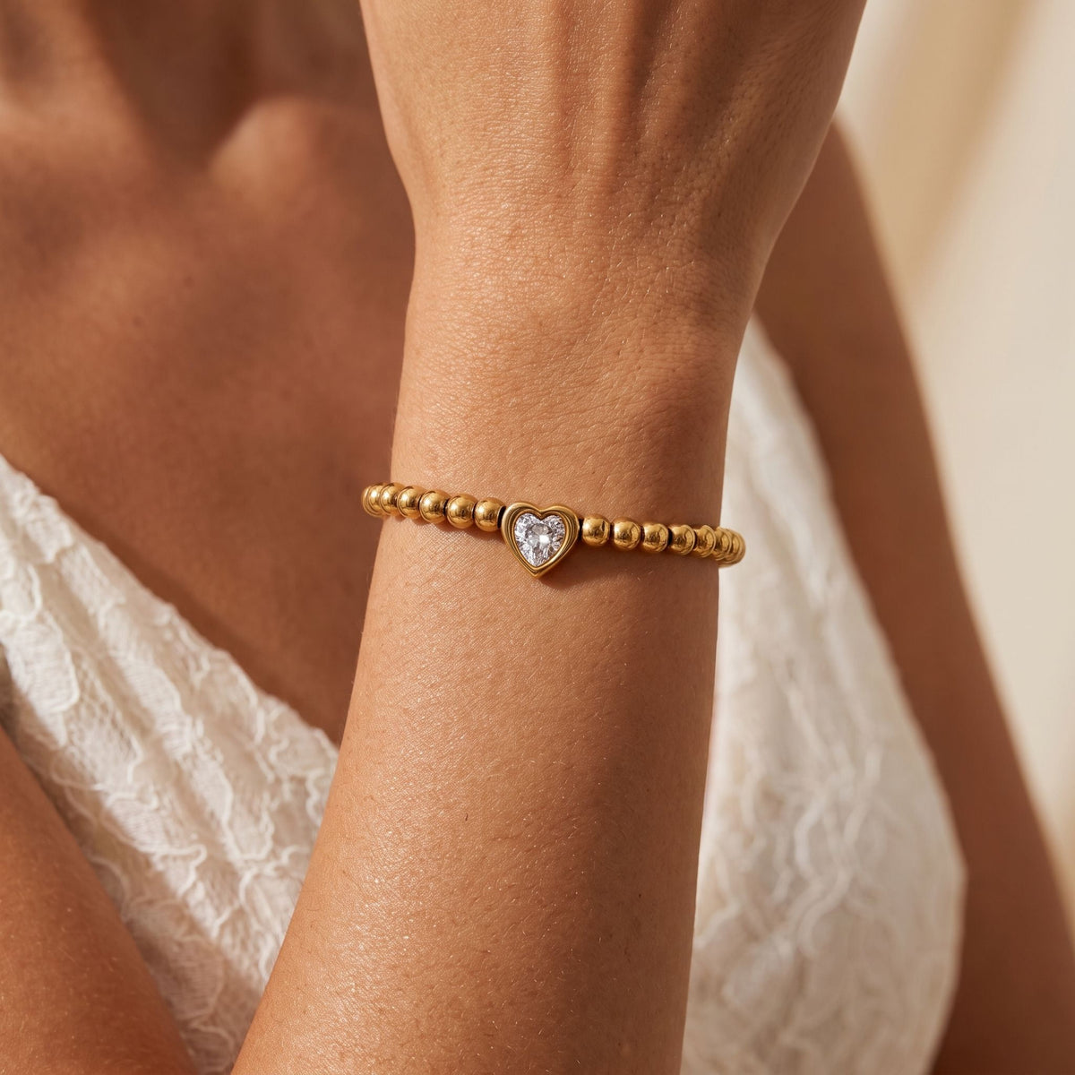 Gold Heart Bracelet worn on the wrist, photographed in natural daylight.
