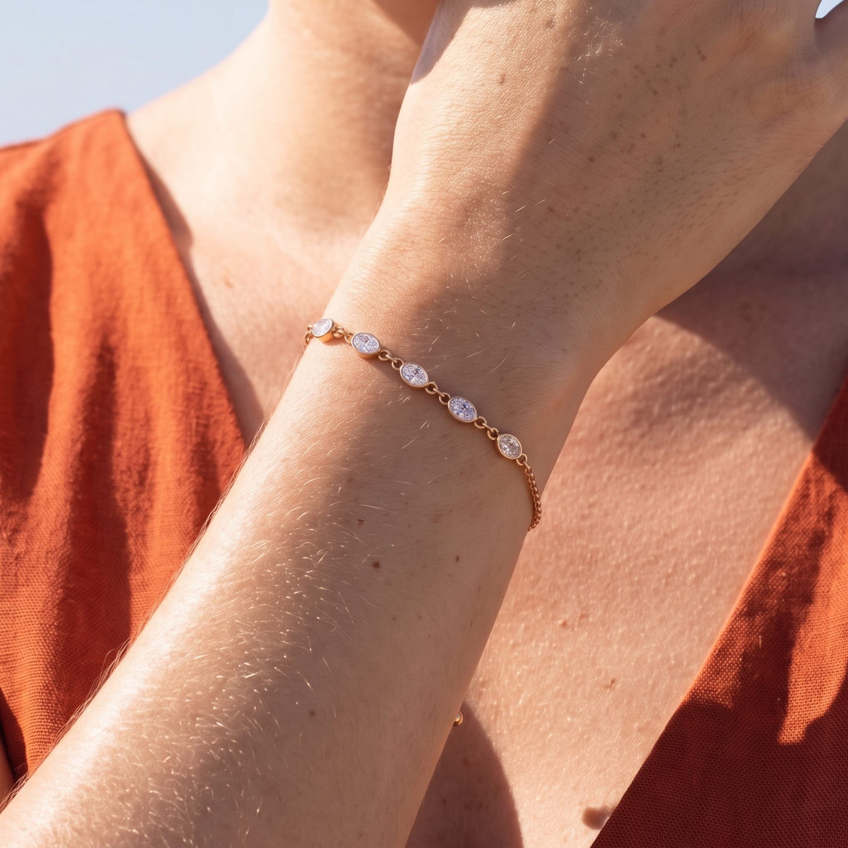 Close-up of the rose gold Oval Bezel Bracelet on the wrist, highlighting its sparkling bezel-set crystals