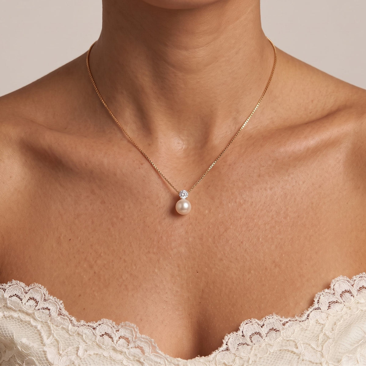 Close-up of the Gold Pearl Pendant worn on the neckline