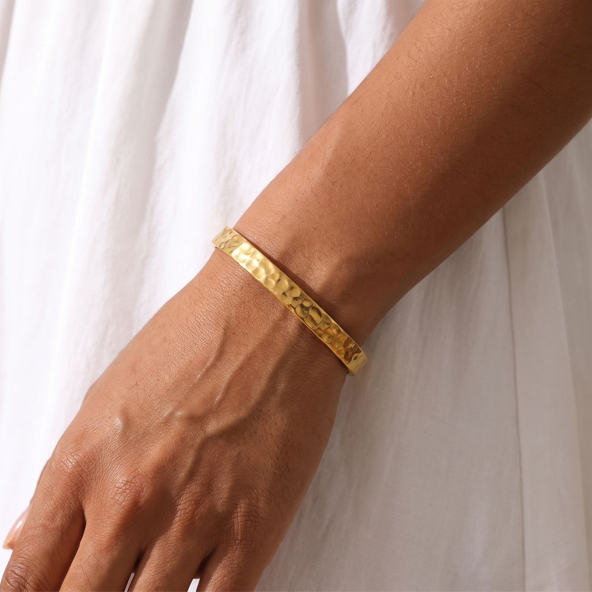 Hammered Bangle worn on the wrist, photographed in natural daylight.