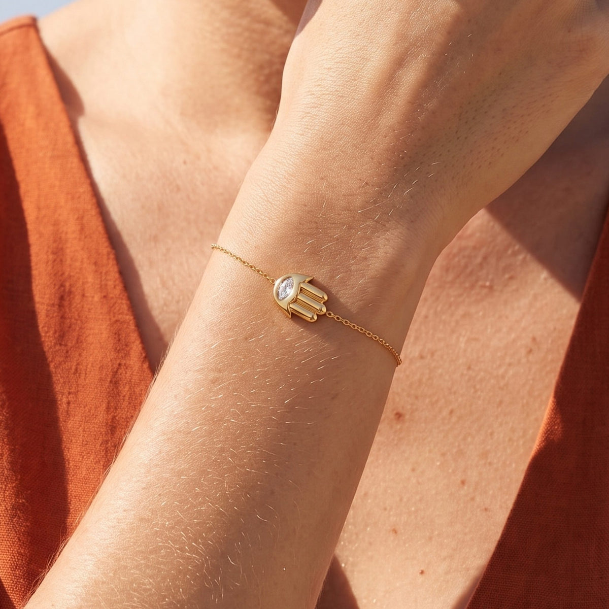 Close-up of the Hamsa Charm Bracelet on the wrist, showcasing its clear crystal eye setting