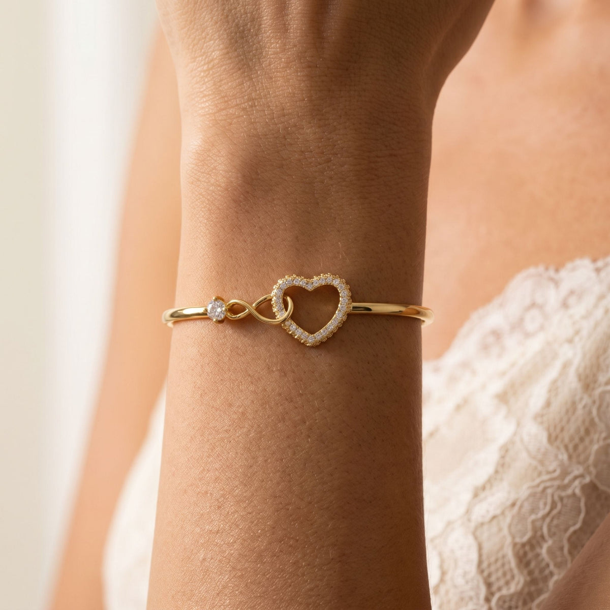 Heart Clasp Bangle worn on the wrist, photographed in natural daylight.