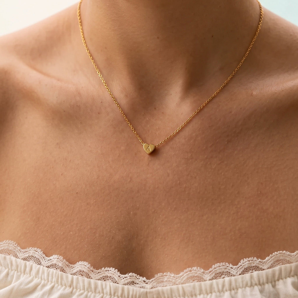 Close-up of the Heart Initial Necklace worn on the neckline