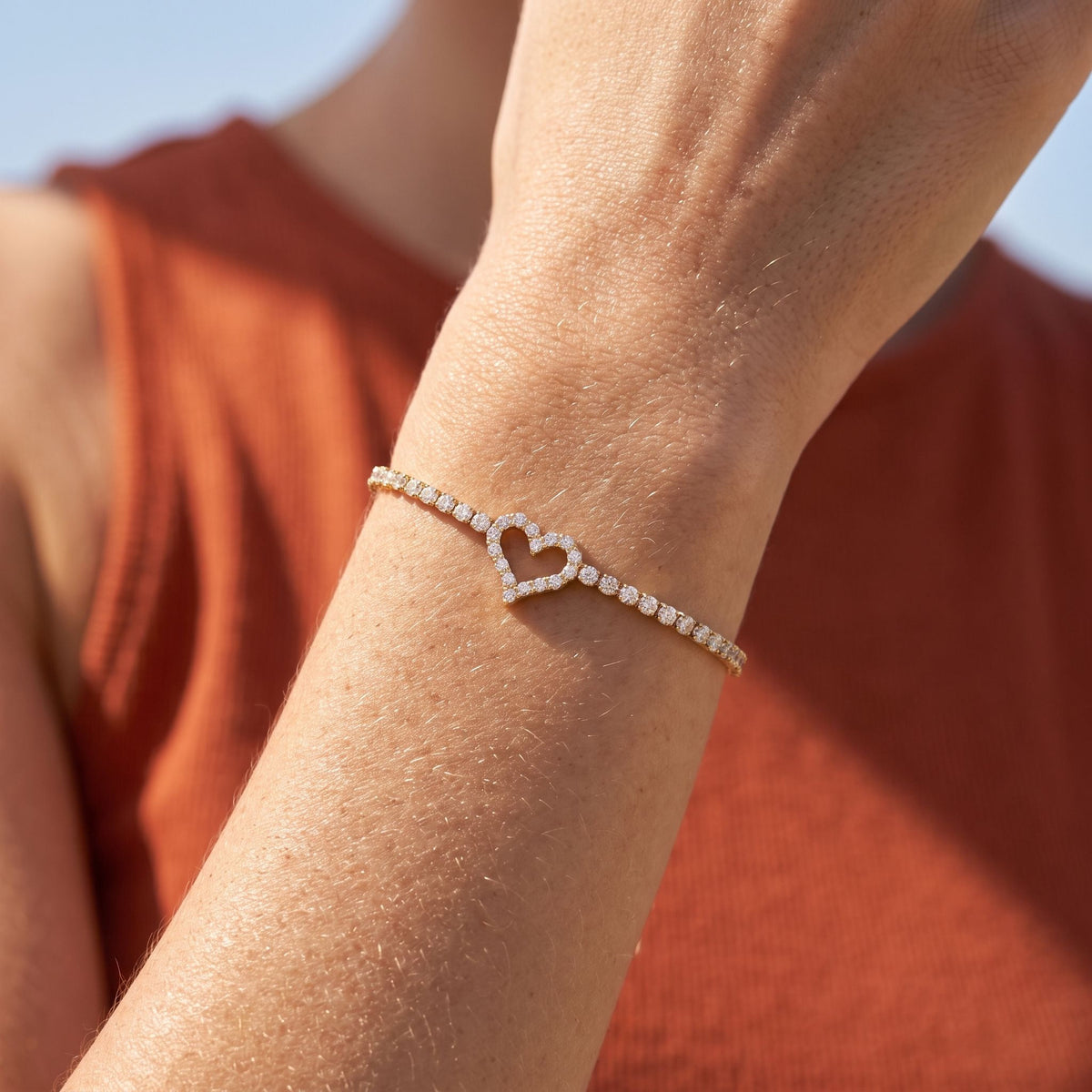 Heart Tennis Bracelet worn on the wrist, photographed in natural daylight.