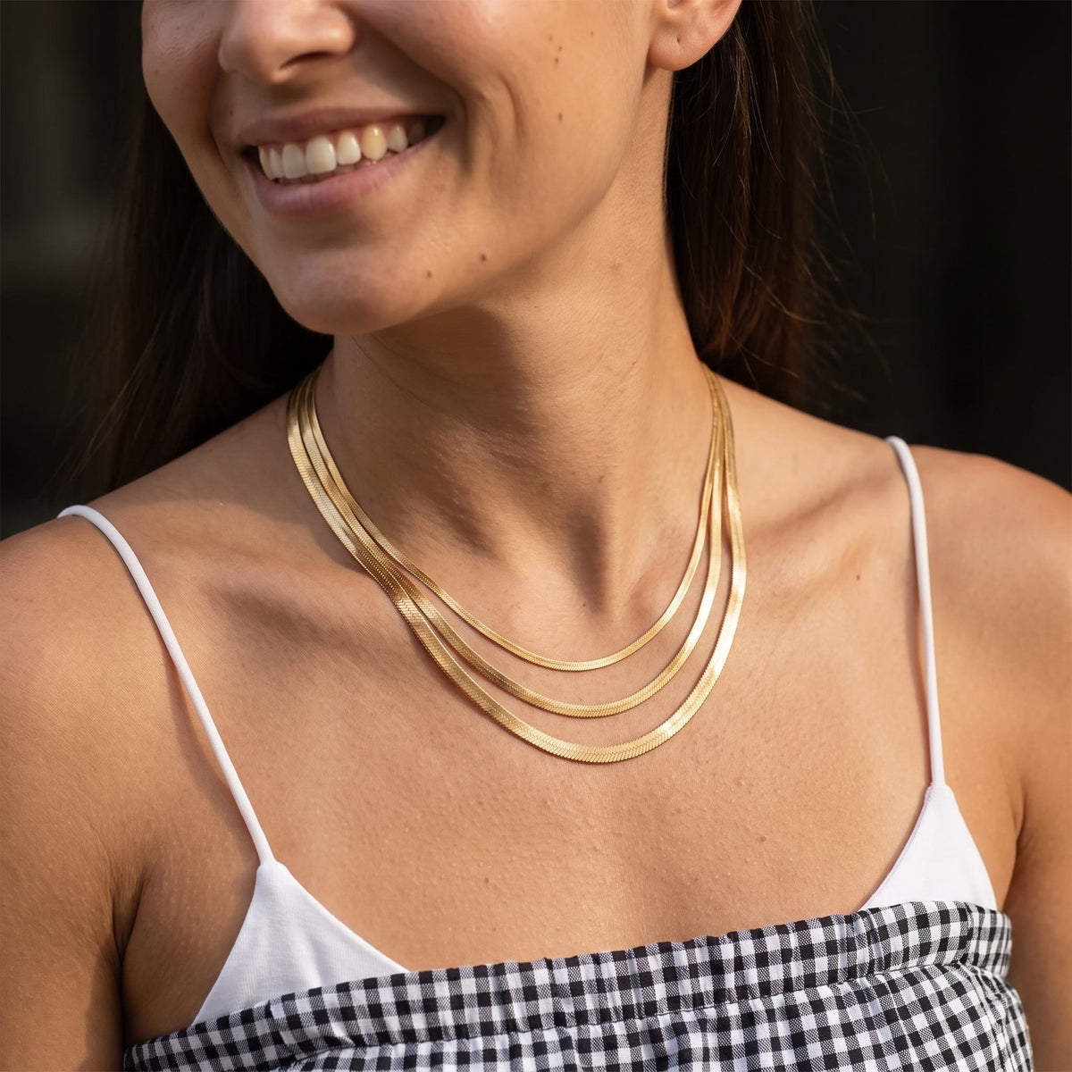 Woman wearing the Herringbone Necklace on the neckline