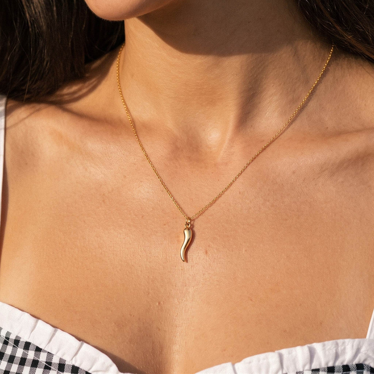 Close-up of the Horn Pendant worn on the neckline
