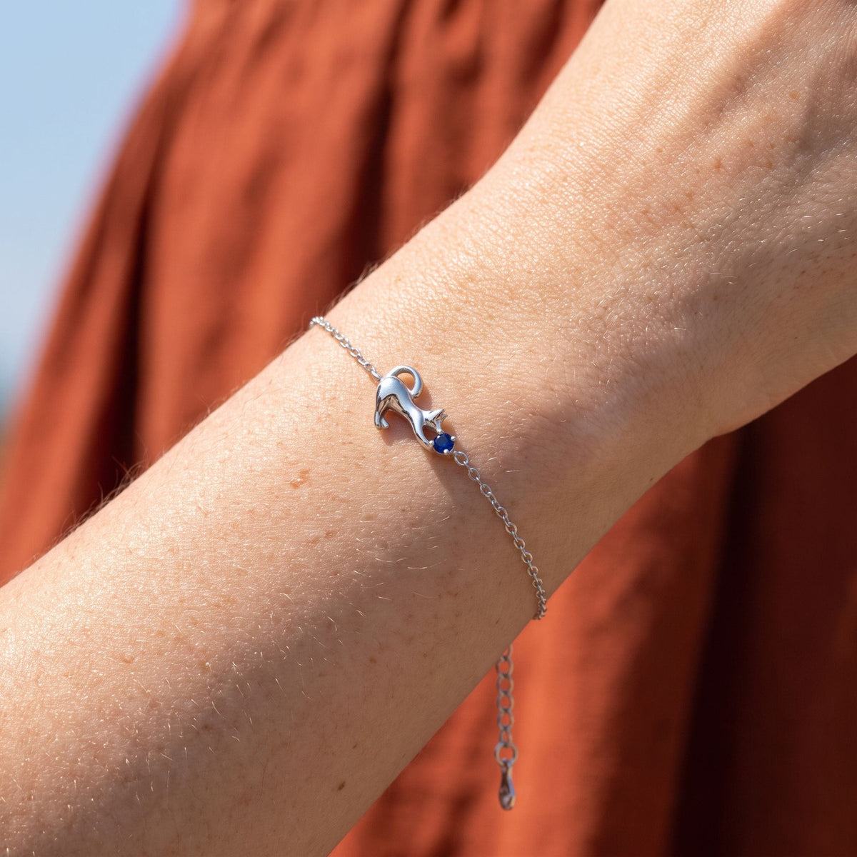 Kitten Bracelet worn on the wrist, photographed in natural daylight.