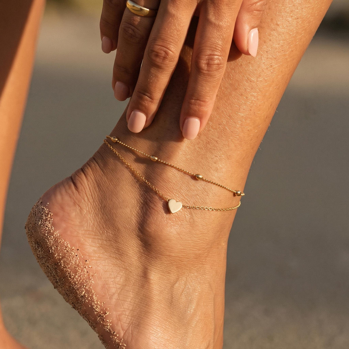 Close-up of the Layered Heart Anklet worn on the ankle