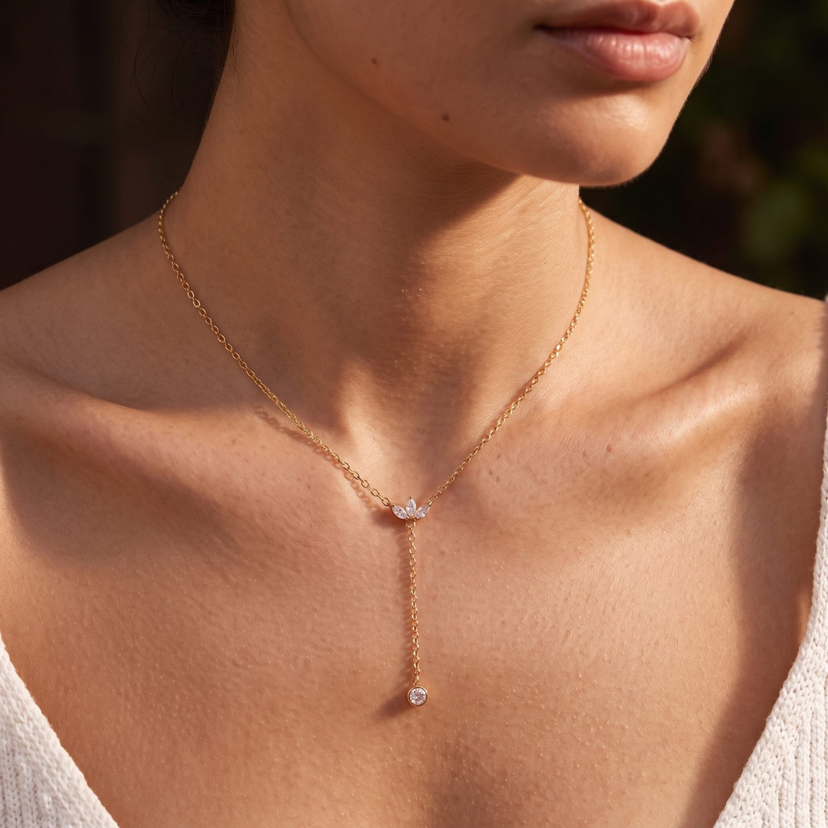 Wider view of a woman wearing the Lotus Lariat Necklace