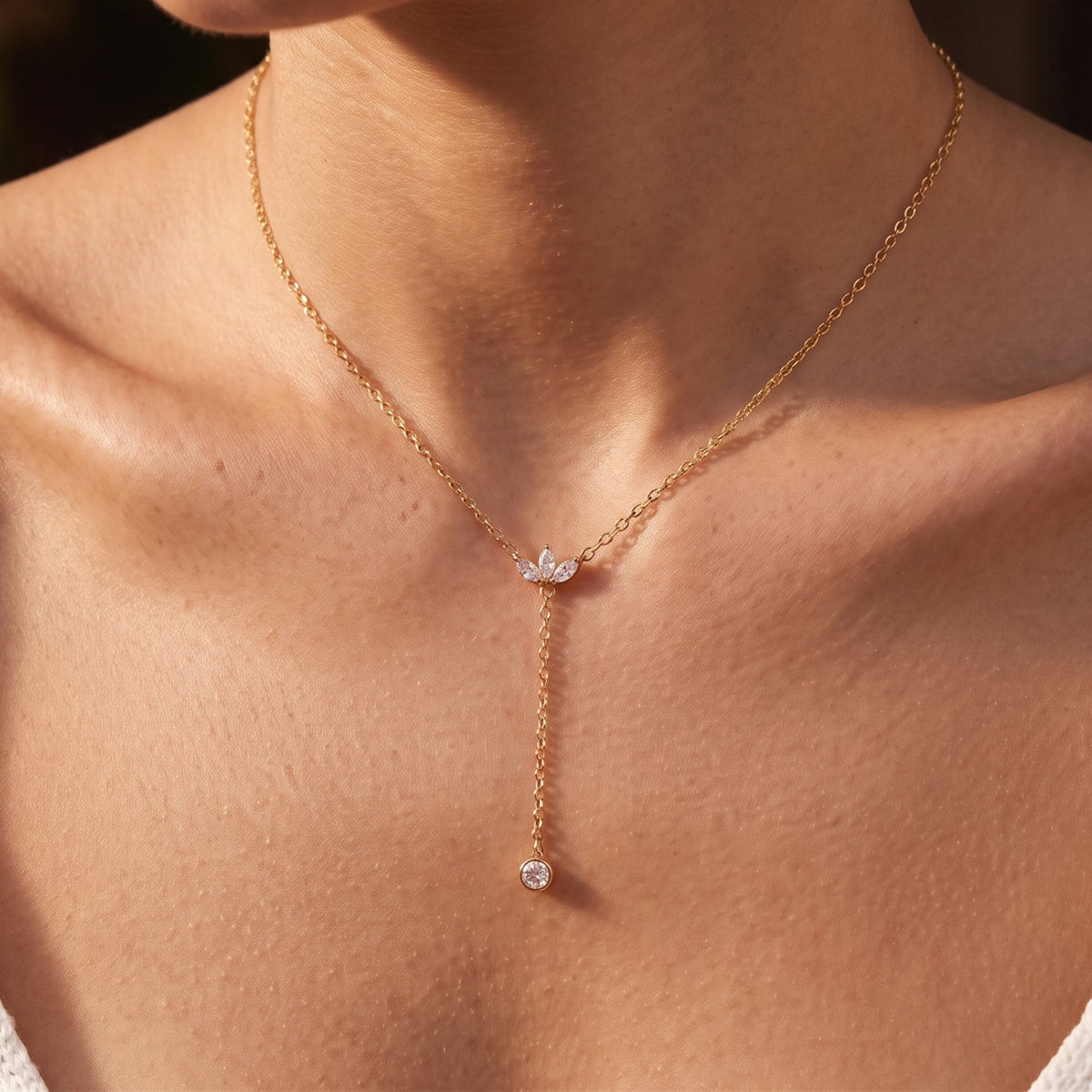Close-up of the Lotus Lariat Necklace worn on the neckline