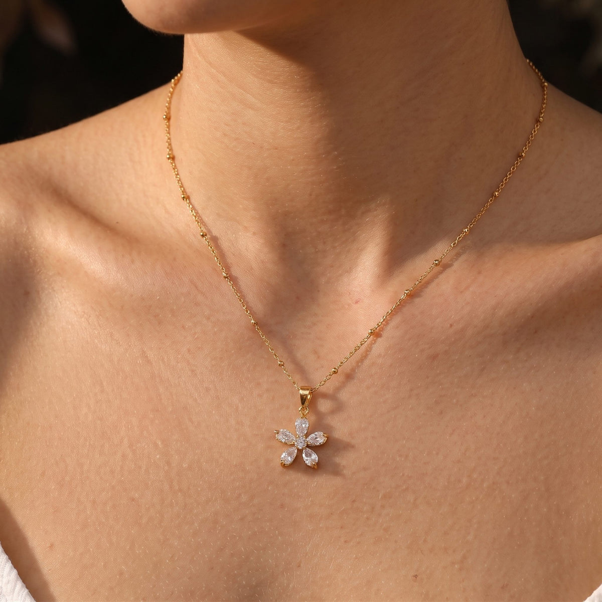 Close-up of the Marquise Bloom Pendant worn on the neckline