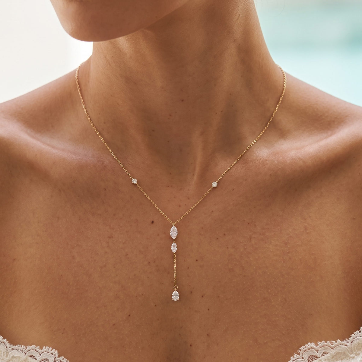 Close-up of the Marquise Lariat Necklace at the collarbone featuring dangling marquise crystals