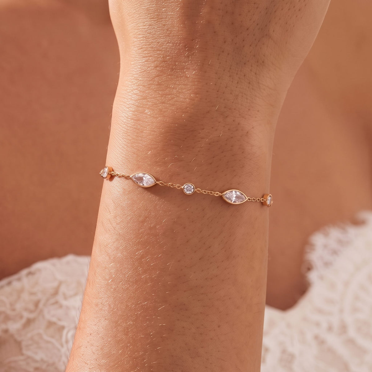Close-up of the Marquise Station Bracelet on the wrist, showing its rose gold chain and sparkling crystals