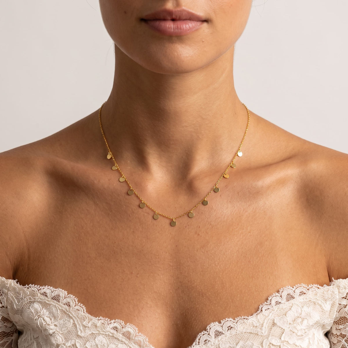 Wider view of a woman wearing the Mini Disc Necklace