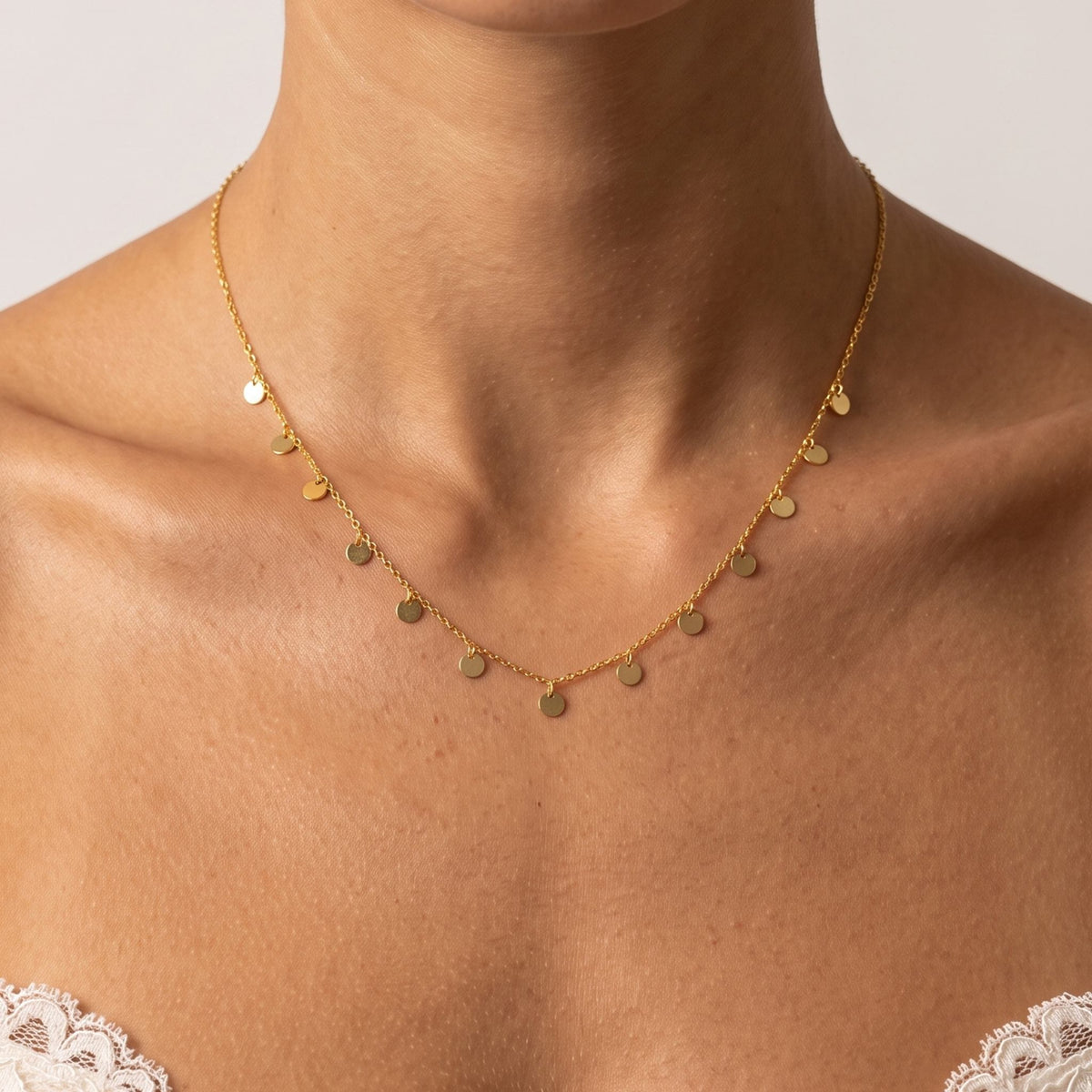 Close-up of the Mini Disc Necklace worn on the neckline