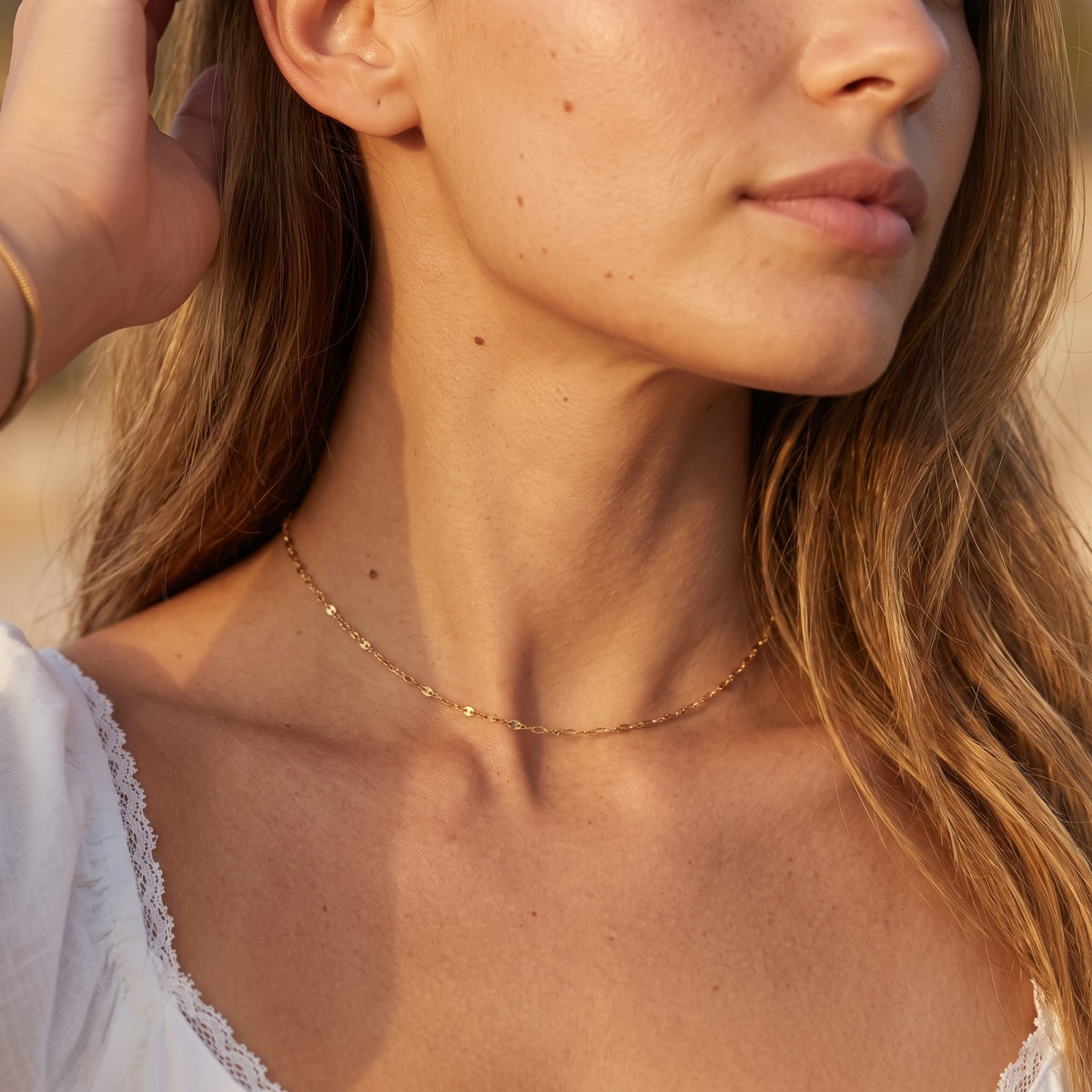 Wider view of a woman wearing the Mirror Chain Choker