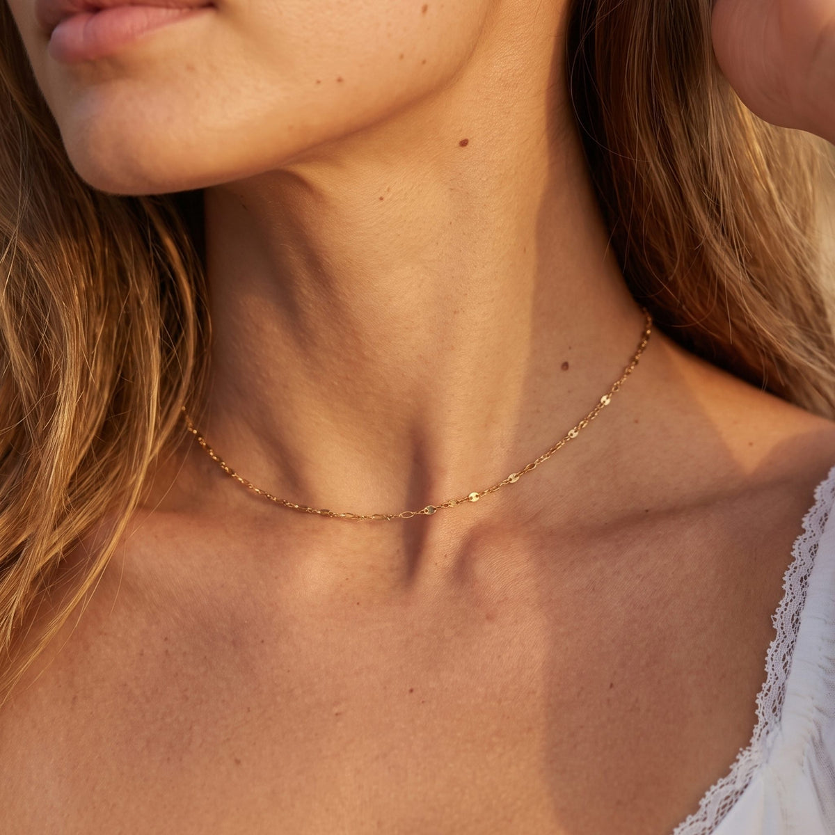 Close-up of the Mirror Chain Choker worn on the neckline