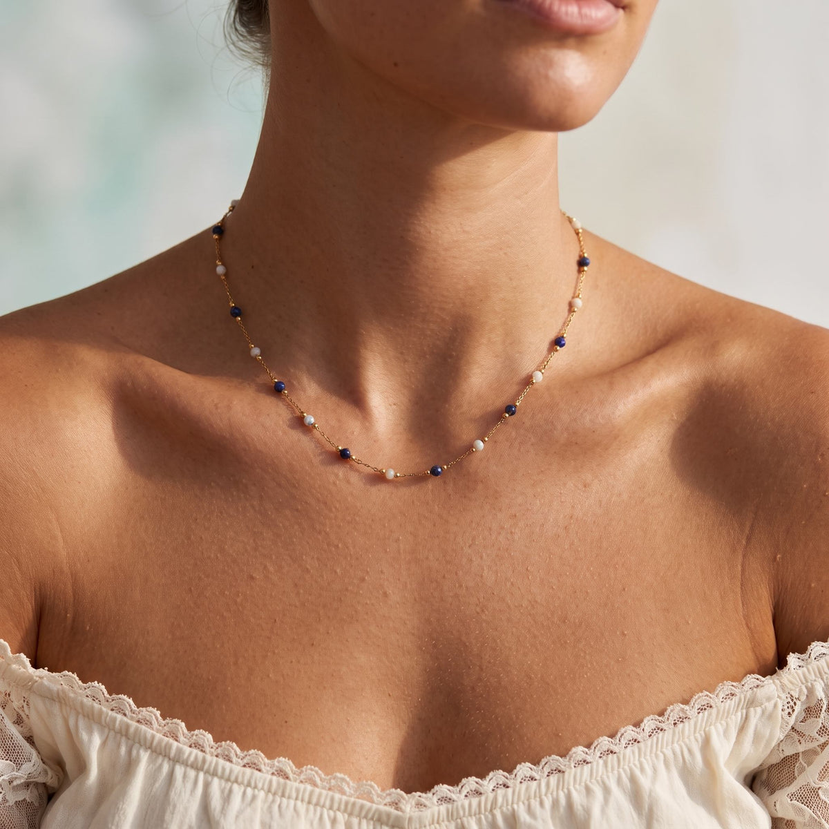 Wider view of a woman wearing the Navy Bead Necklace