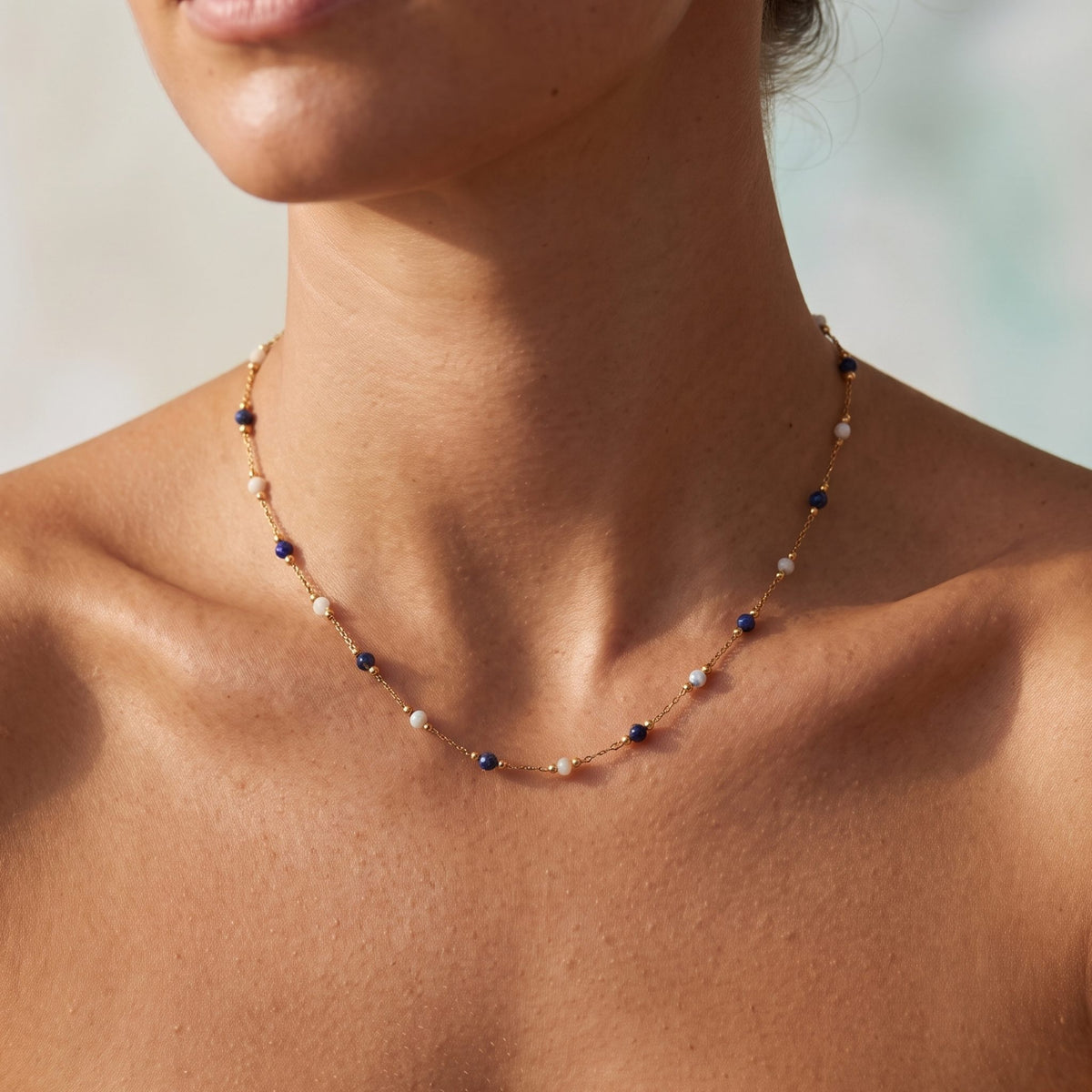 Close-up of the Navy Bead Necklace worn on the neckline