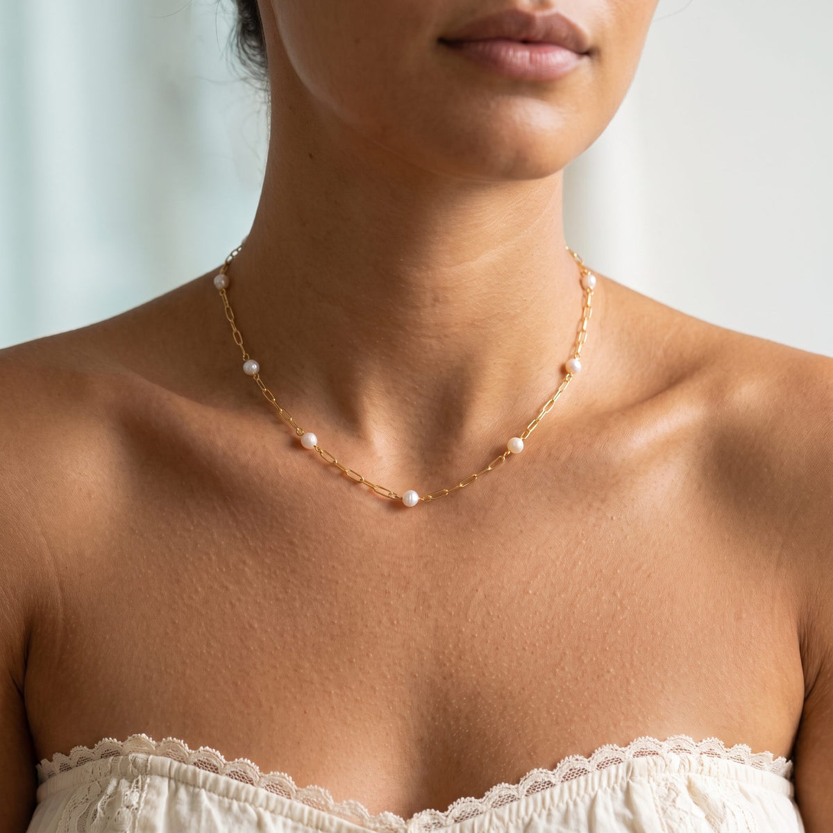 Wider view of a woman wearing the Paperclip Pearl Necklace