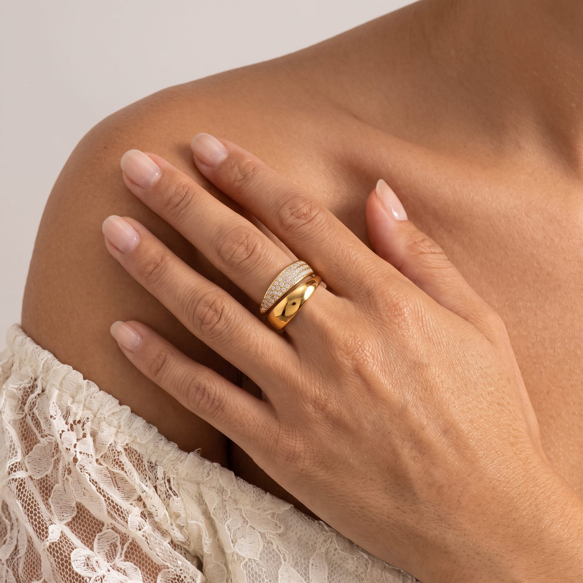 Woman wearing the Pavé Bypass Ring on her ring finger, her hand resting on her shoulder