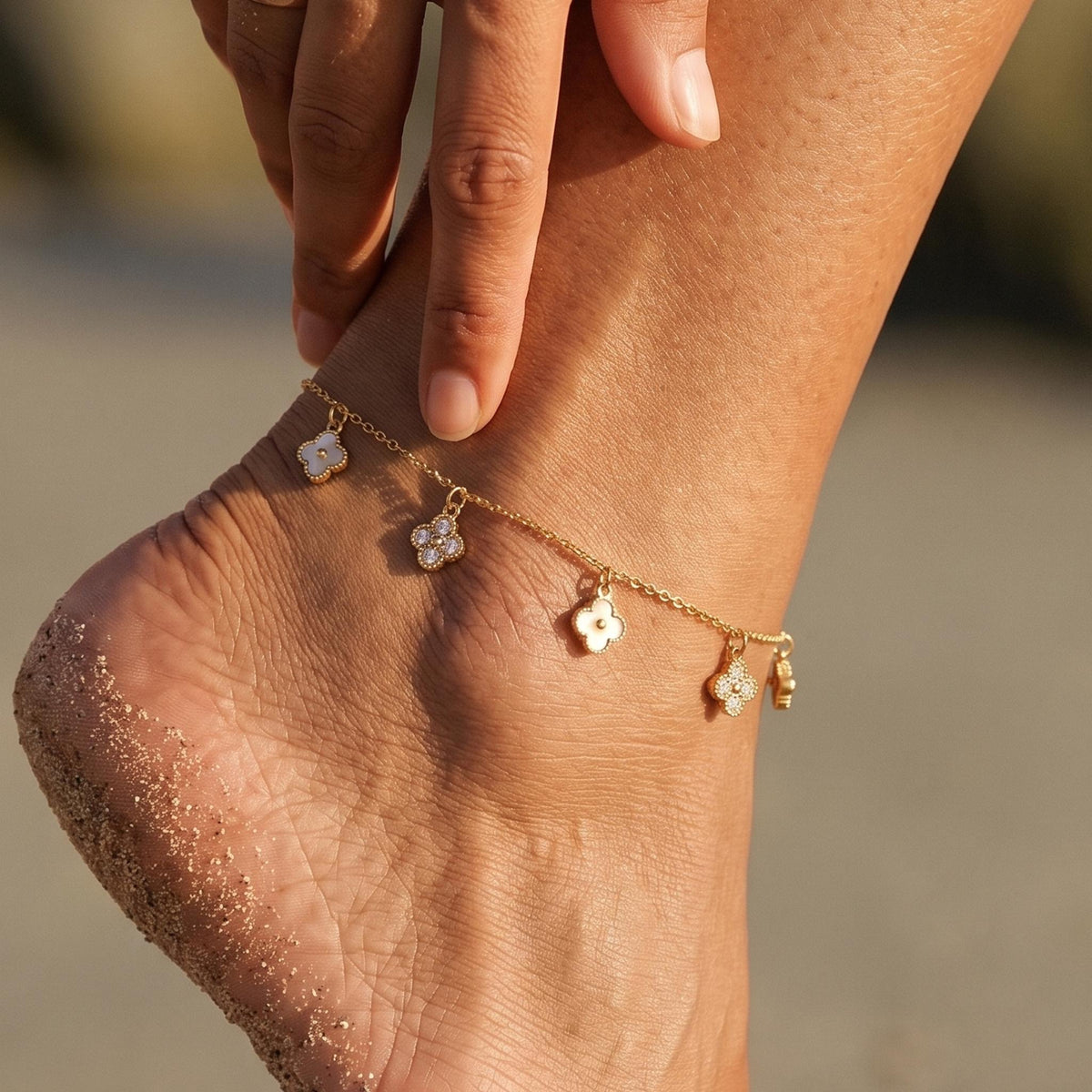 Close-up of the Pavé Clover Anklet worn on the ankle