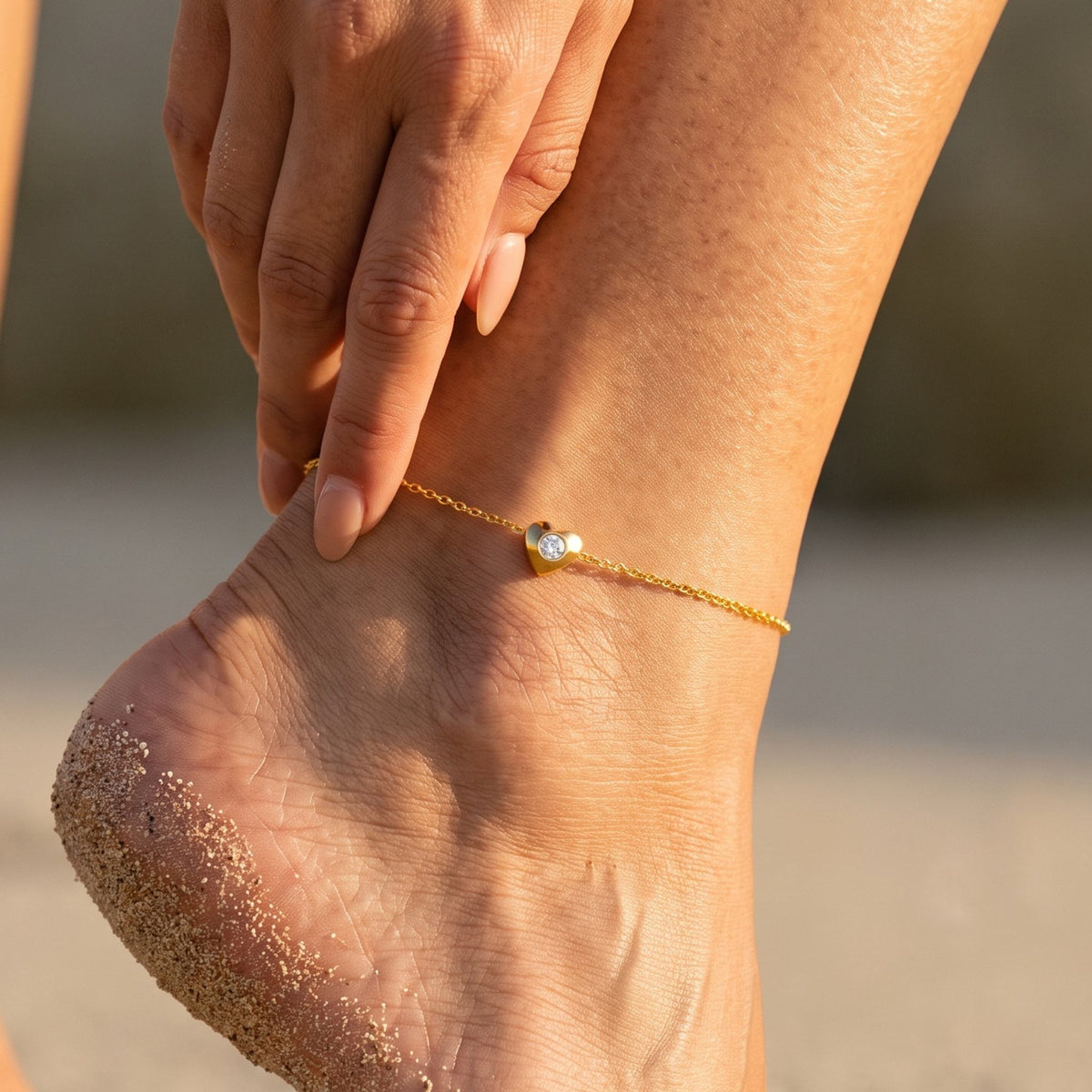 Close-up of the Pavé Heart Anklet worn on the ankle