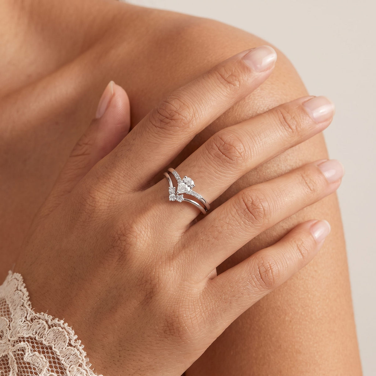 Wider view of a hand wearing the Pear Ring Set