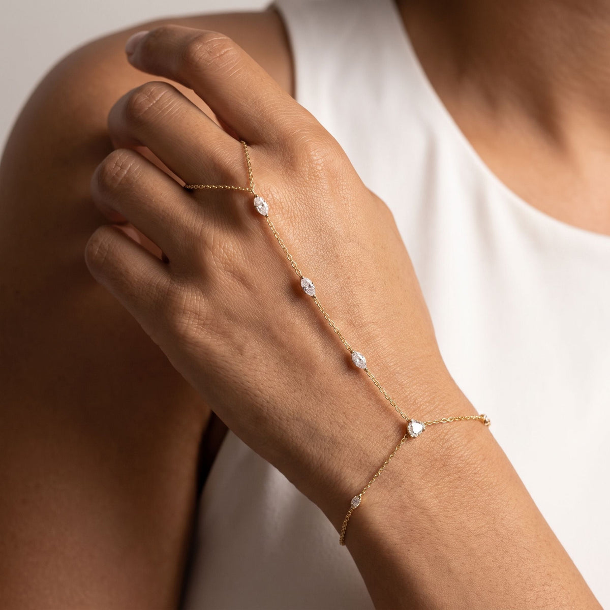 Pear Stone Hand Chain worn across the back of the hand, with the ring on the finger and the chain at the wrist.