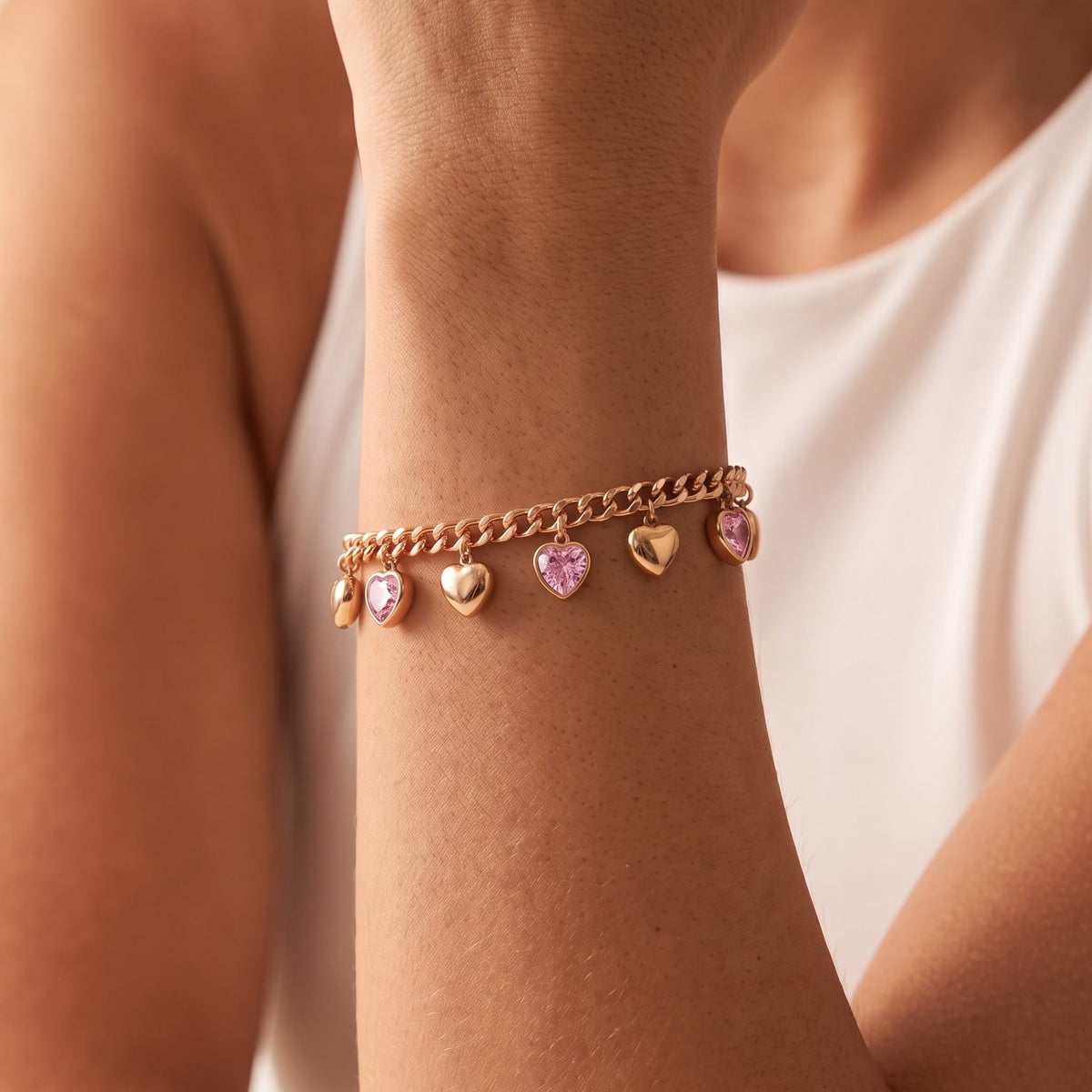 Pink Heart Bracelet in rose gold worn on the wrist, photographed in natural daylight