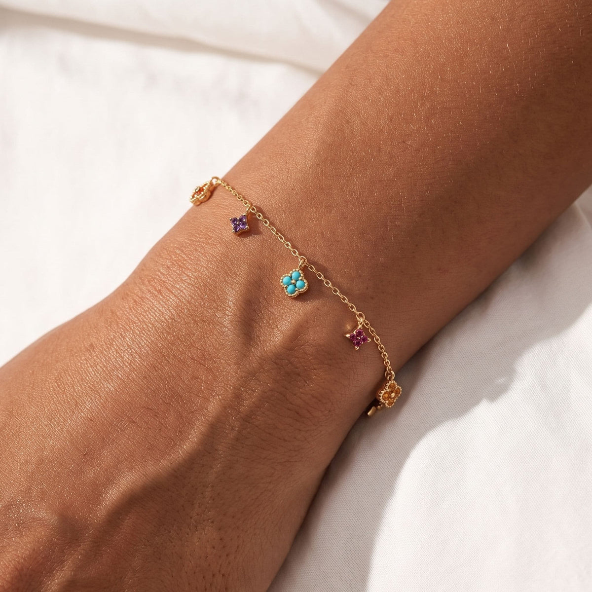 Prism Charm Bracelet worn on the wrist, photographed in natural daylight.
