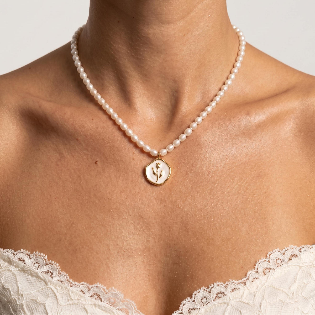 Close-up of the Rose Coin Necklace worn on the neckline