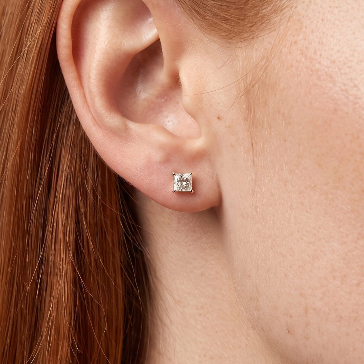 Woman wearing the Roxane Square Crystal Gold Studs on the lobe, showing the delicate gold prongs