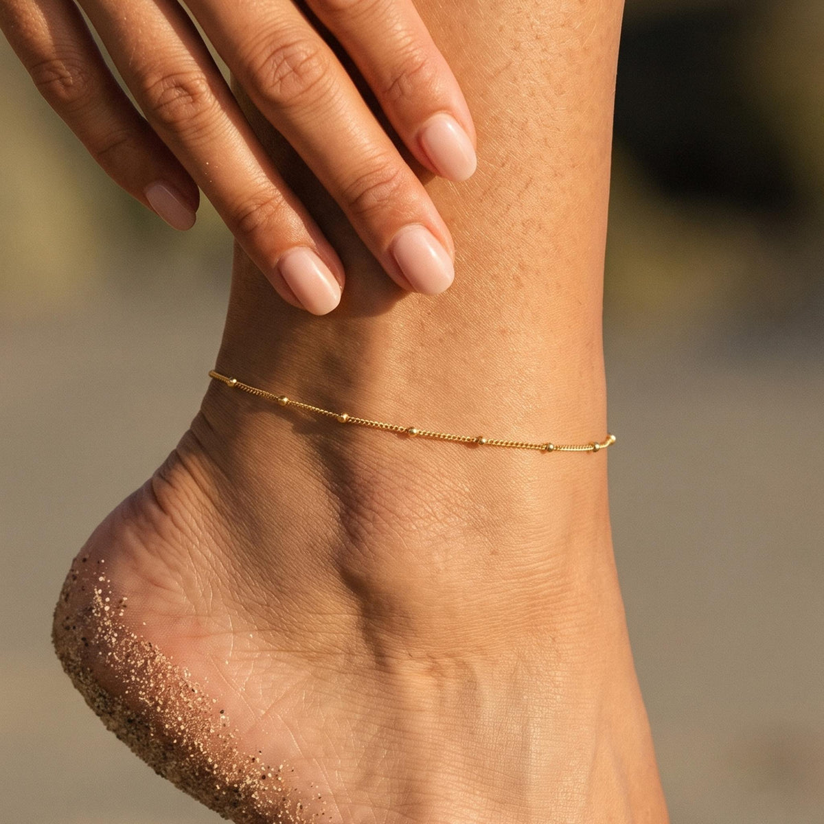 Close-up of the Satellite Chain Anklet worn on the ankle