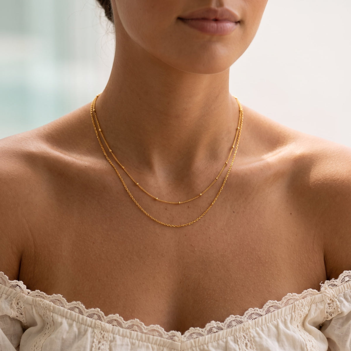 Wider view of a woman wearing the Satellite Layer Necklace