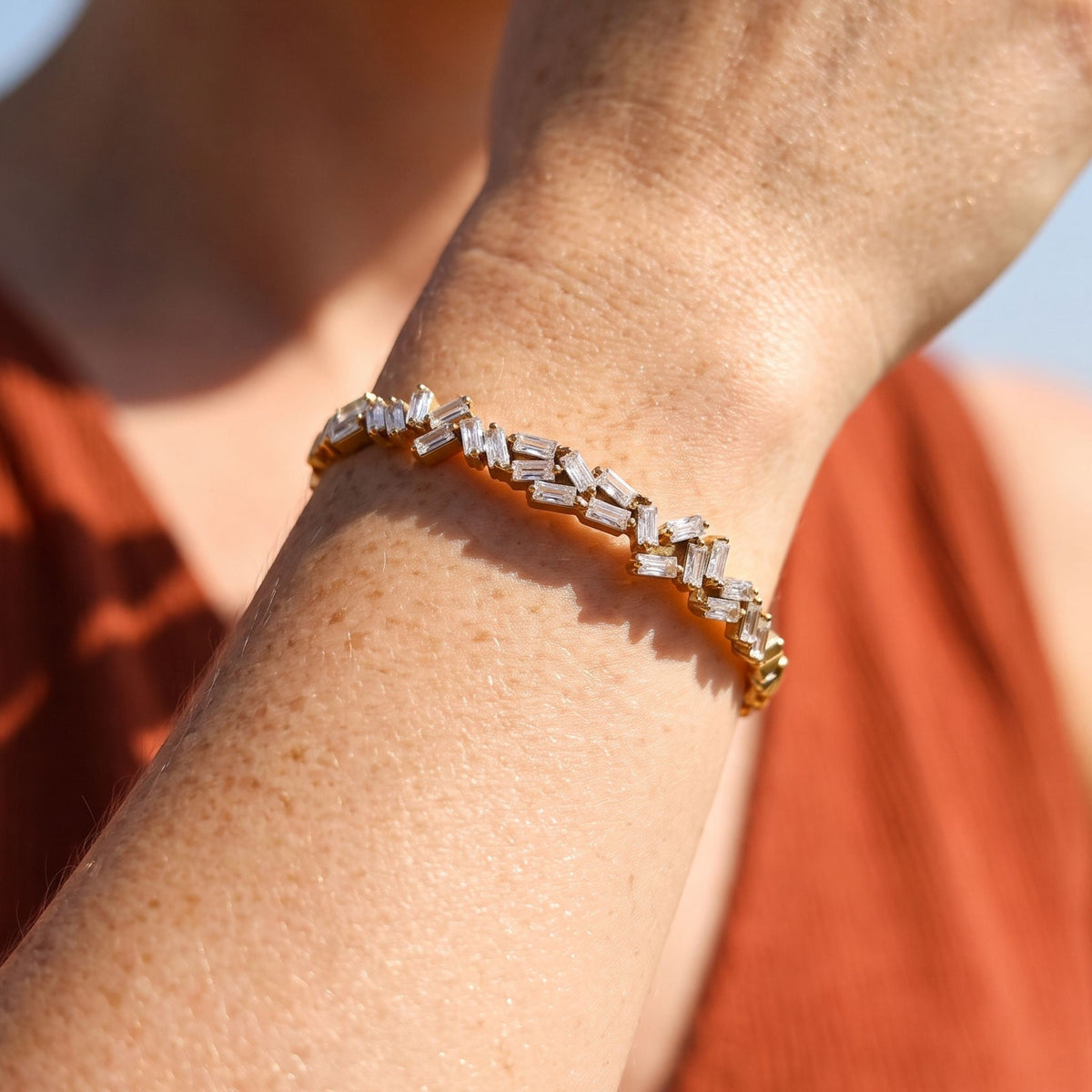 Scattered Baguette Bangle worn on the wrist, photographed in natural daylight.