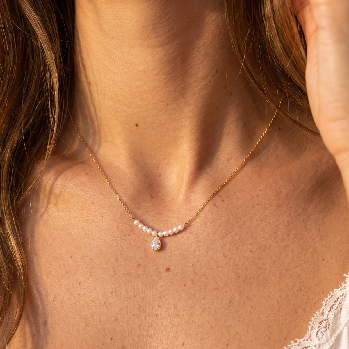 Close-up of the Seed Pearl Necklace at the collarbone, highlighting tiny pearls and a teardrop crystal