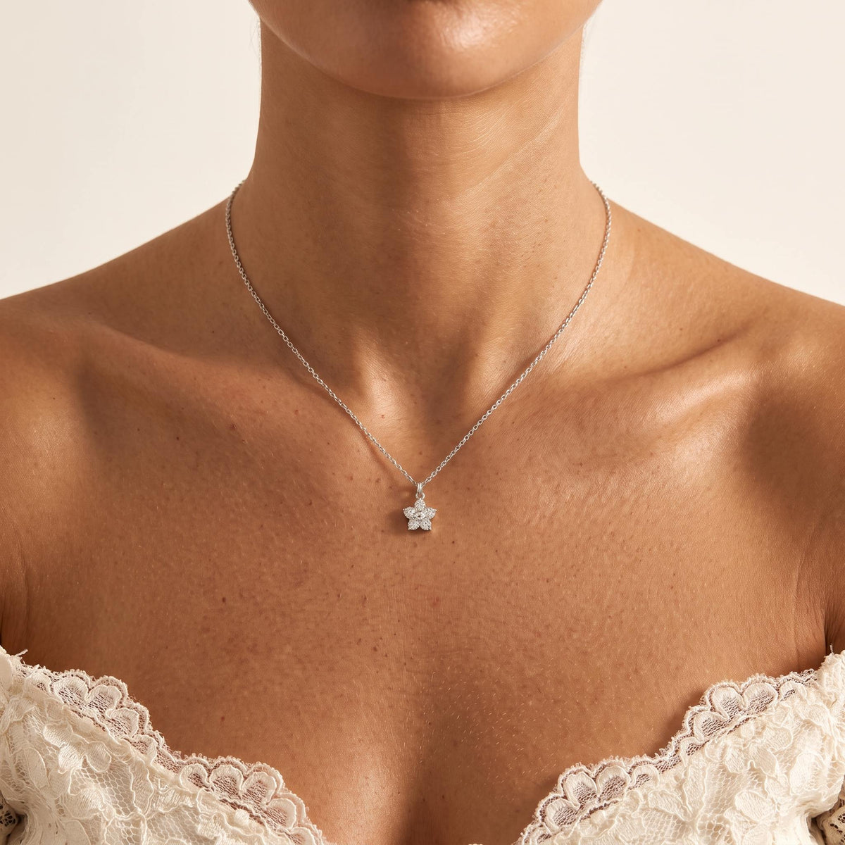 Wider view of a woman wearing the Silver Bloom Pendant