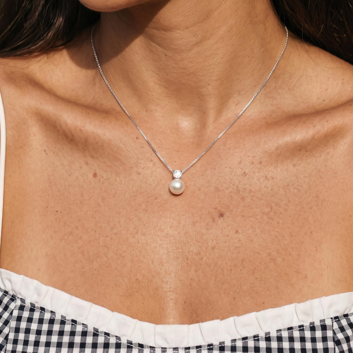 Close-up of the Silver Pearl Pendant worn on the neckline