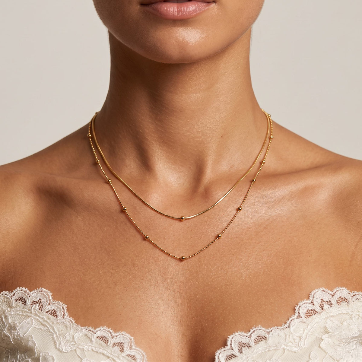 Close-up of the Snake Layer Necklace worn on the neckline