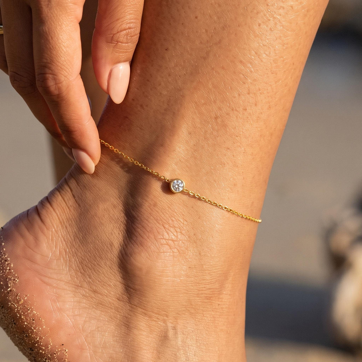 Close-up of the Solitaire Anklet worn on the ankle