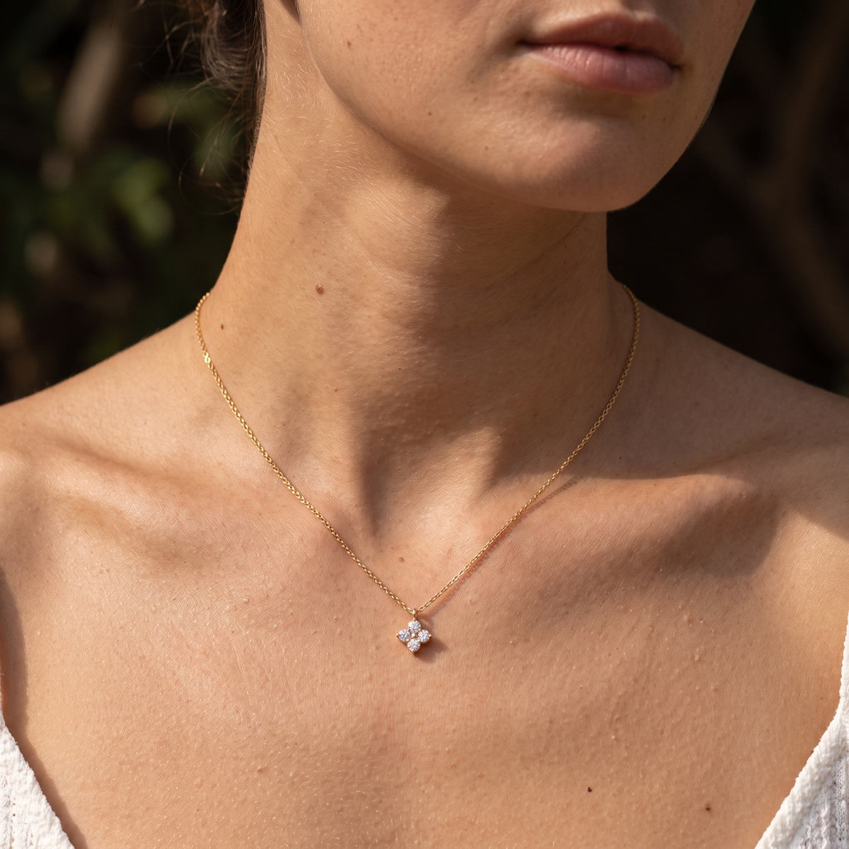Wider view of a woman wearing the Solo Clover Pendant