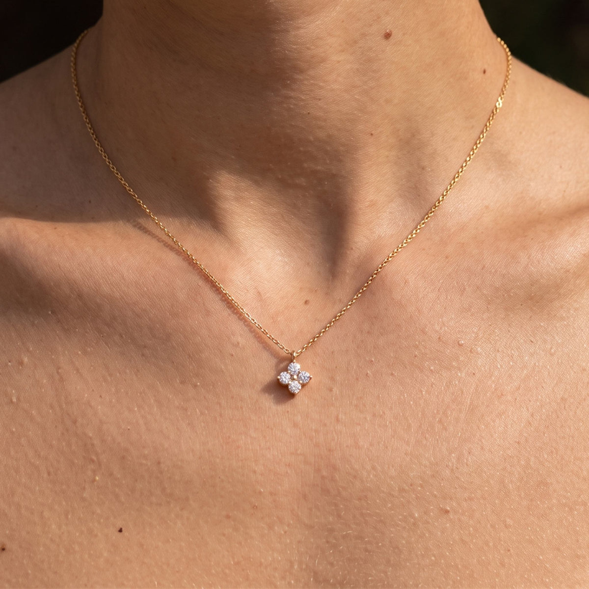 Close-up of the Solo Clover Pendant worn on the neckline