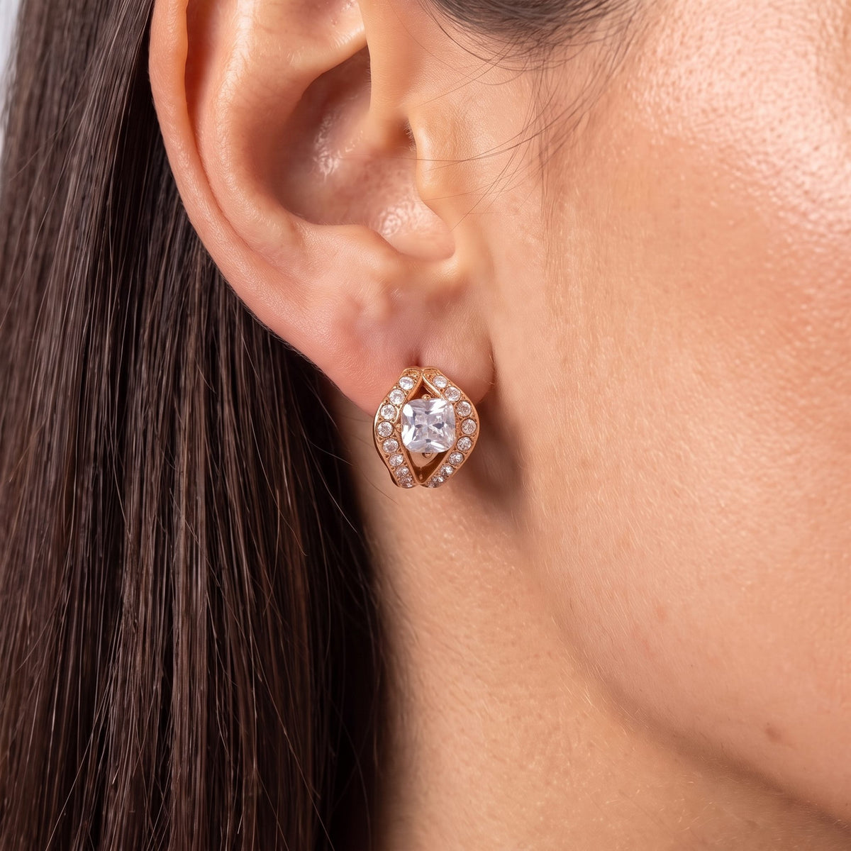 Close-up of the Split Halo Huggies on an ear, highlighting the rose gold setting and sparkling crystals