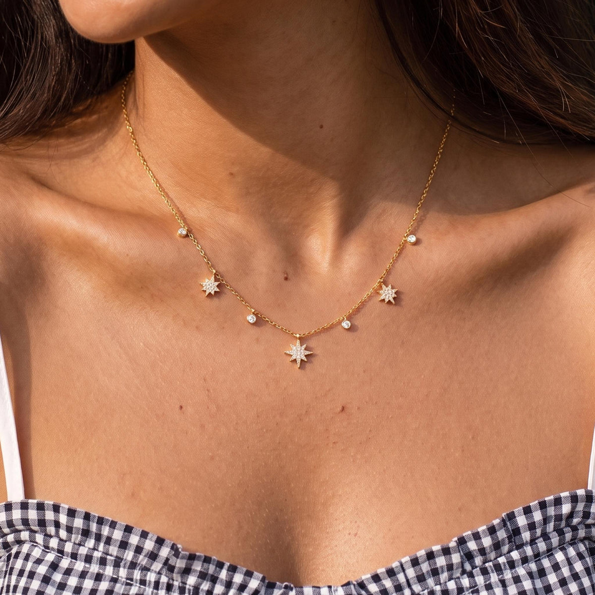 Close-up of the Star Charm Necklace worn on the neckline
