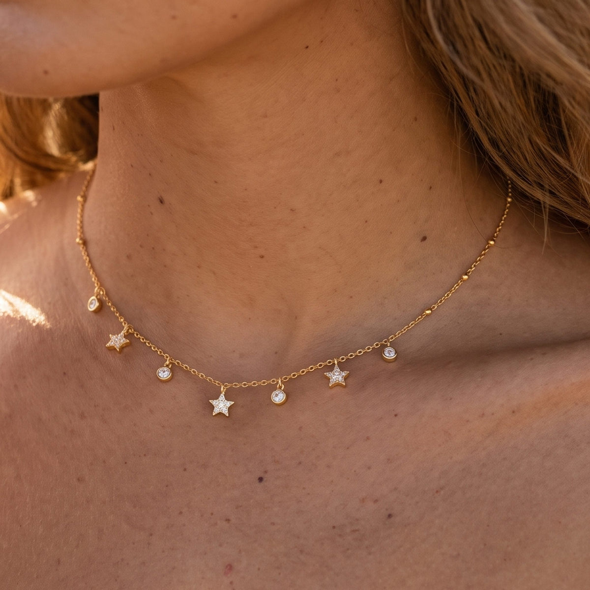 Close-up of the Star Drop Necklace at the collarbone, showcasing delicate star and crystal dangles