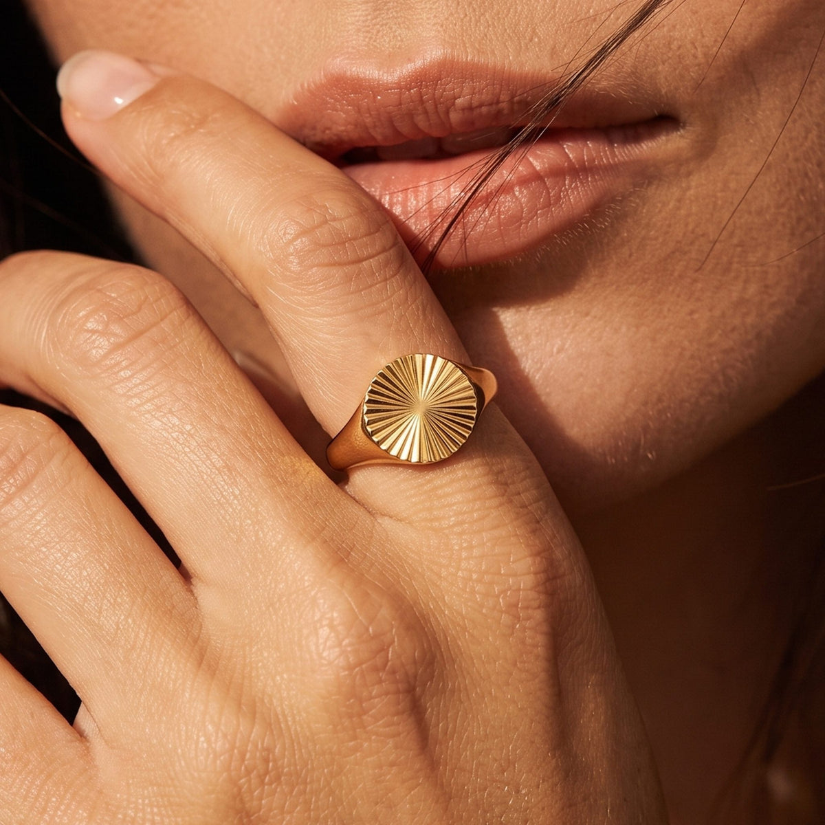 Close-up of the Sunray Signet Ring worn on the finger