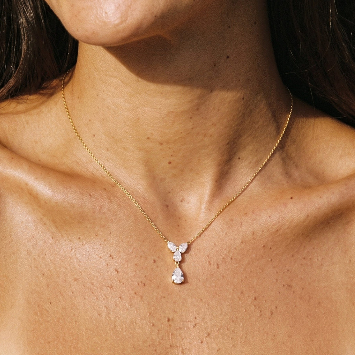 Close-up of the Teardrop Cluster Pendant at the collarbone, featuring sparkling crystal stones