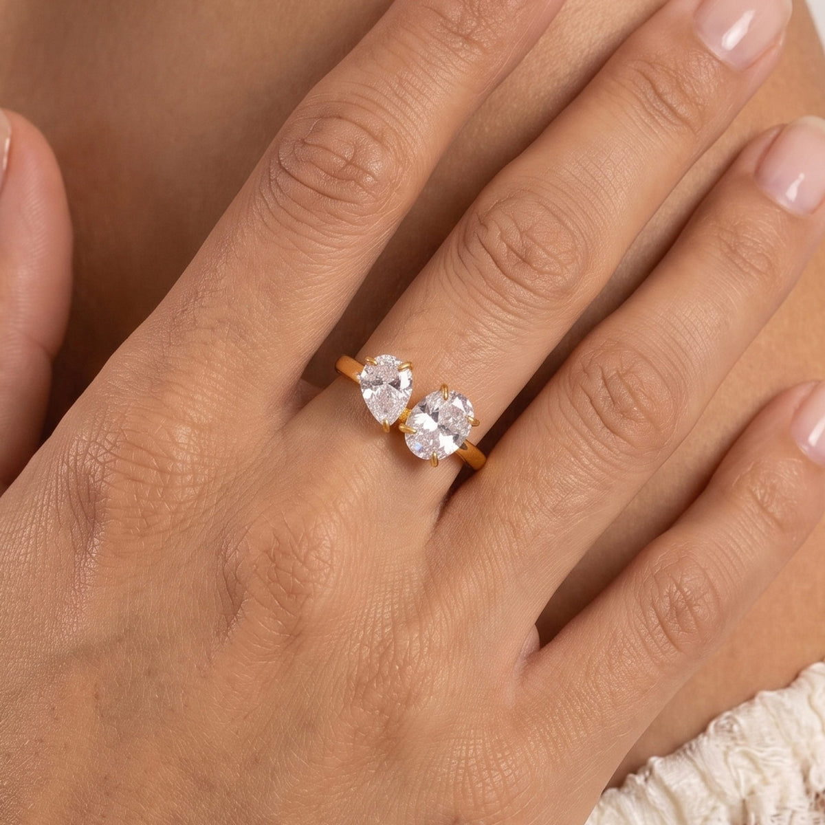 Close-up of the Toi-et-Moi Ring on the ring finger, featuring pear and oval cut crystals